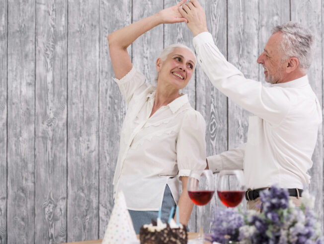 Happy senior couple dancing at birthday party